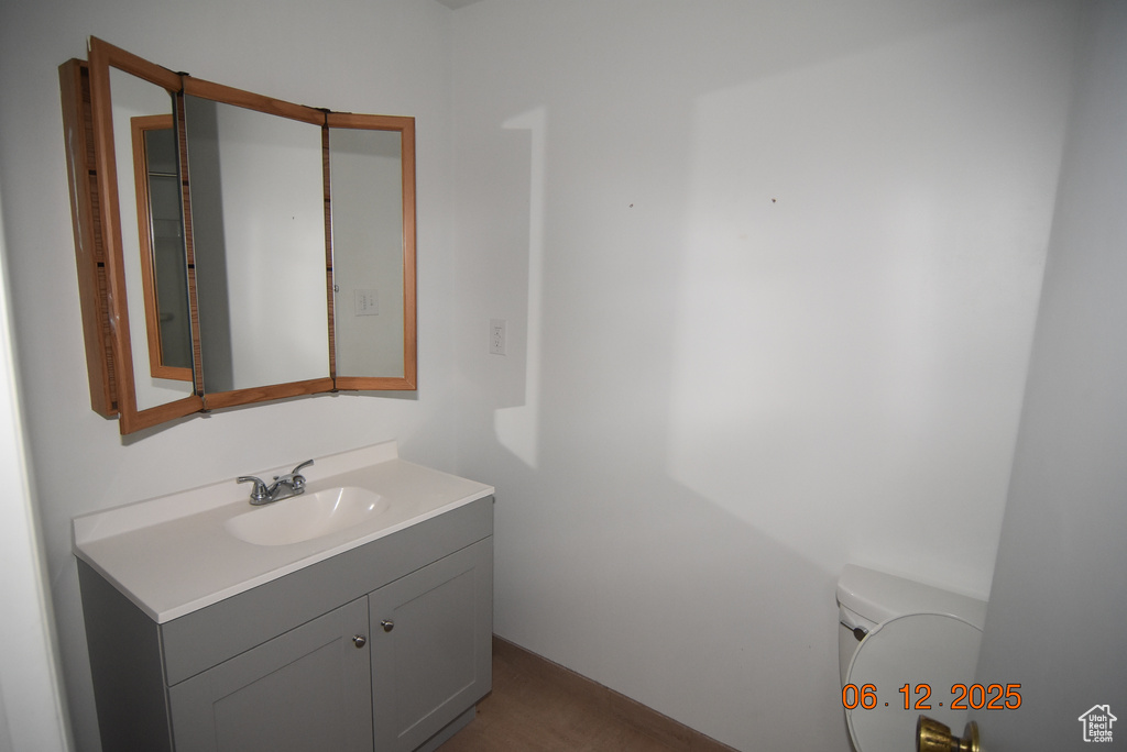 Bathroom featuring vanity and toilet