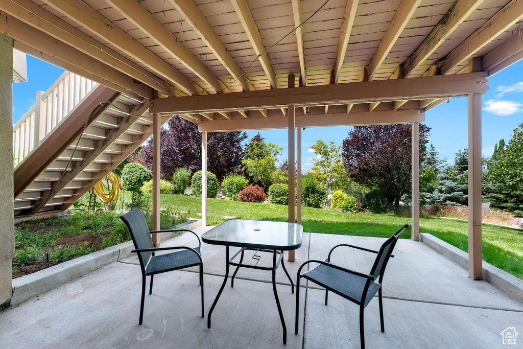 View of patio featuring stairway and outdoor dining space