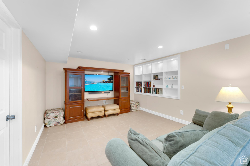 Living room with tile patterned flooring and recessed lighting
