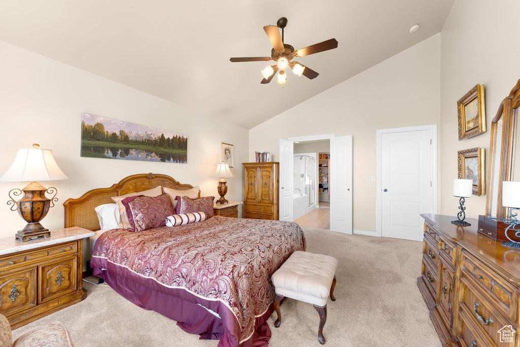 Bedroom with light colored carpet, high vaulted ceiling, and a ceiling fan