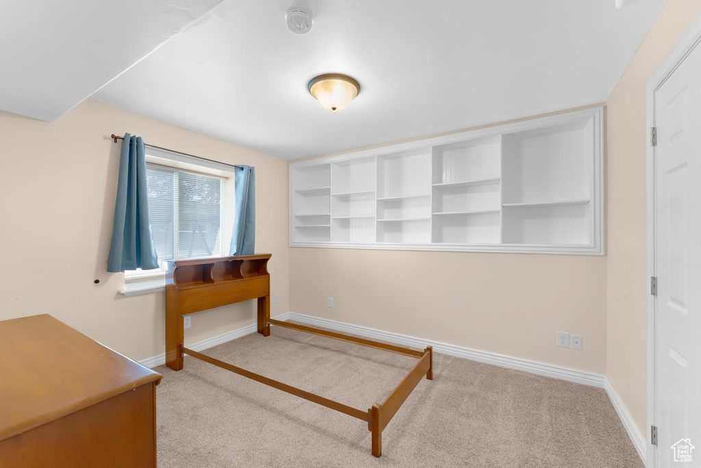 Unfurnished bedroom with carpet and baseboards