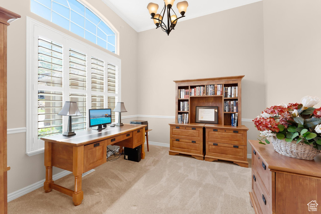 Office space with a chandelier, healthy amount of natural light, and light colored carpet