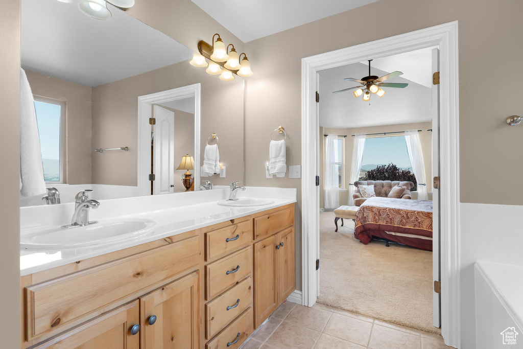 Full bathroom featuring double vanity, ceiling fan, connected bathroom, and tile patterned floors