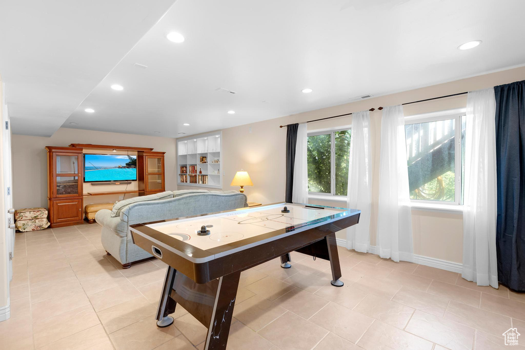 Game room with recessed lighting and light tile patterned floors