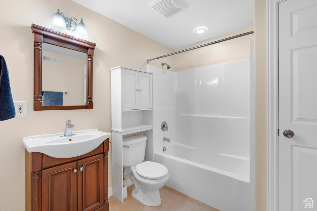 Bathroom featuring vanity, bathtub / shower combination, and tile patterned floors