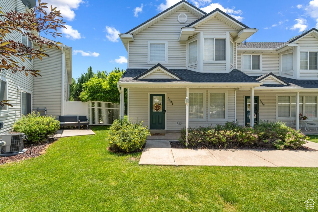 Multi unit property with a shingled roof and covered porch