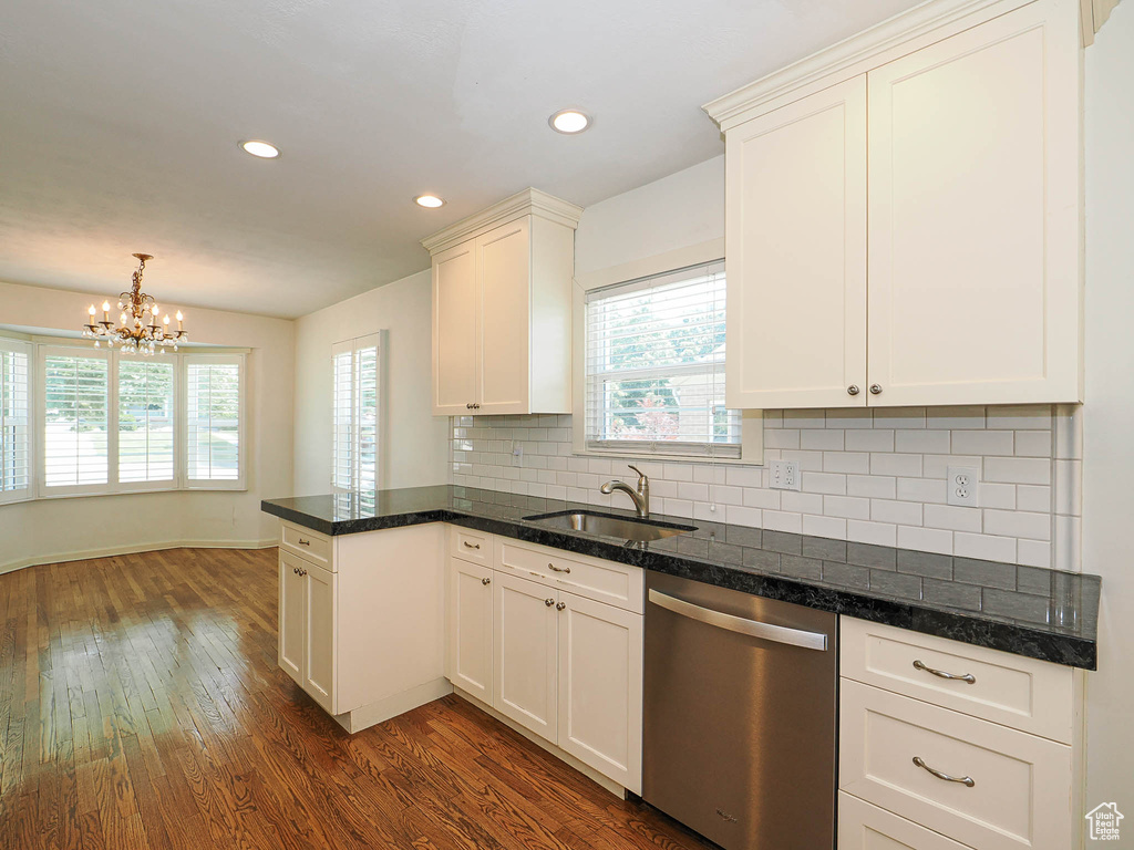 Kitchen featuring stainless steel dishwasher, dark wood-style flooring, healthy amount of natural light, a chandelier, and recessed lighting