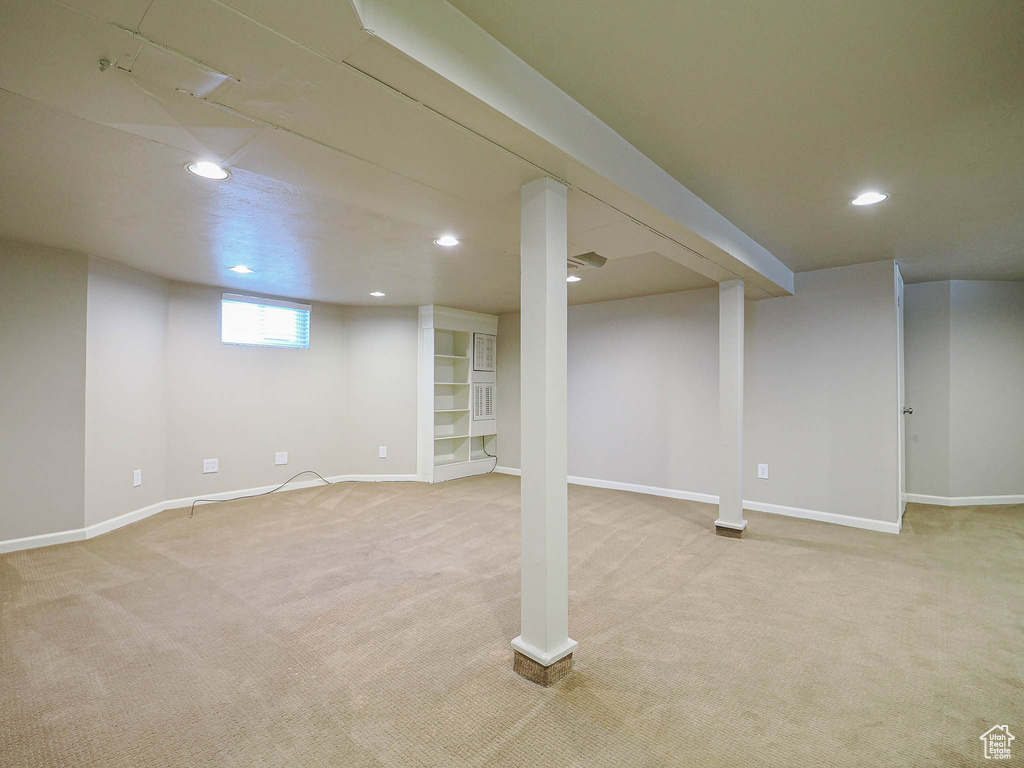 Basement with light carpet and recessed lighting