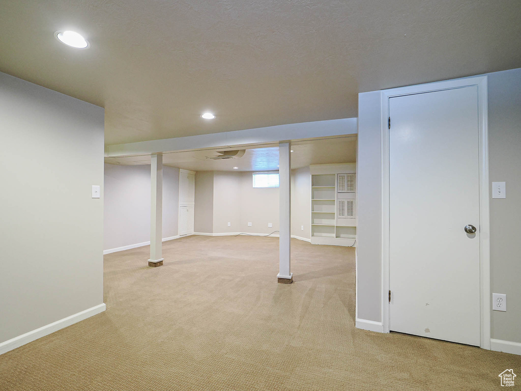 Basement featuring light colored carpet and recessed lighting