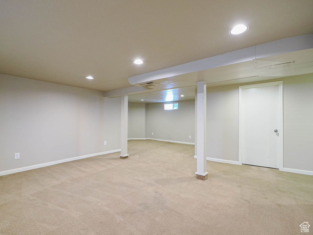 Basement with light colored carpet and recessed lighting