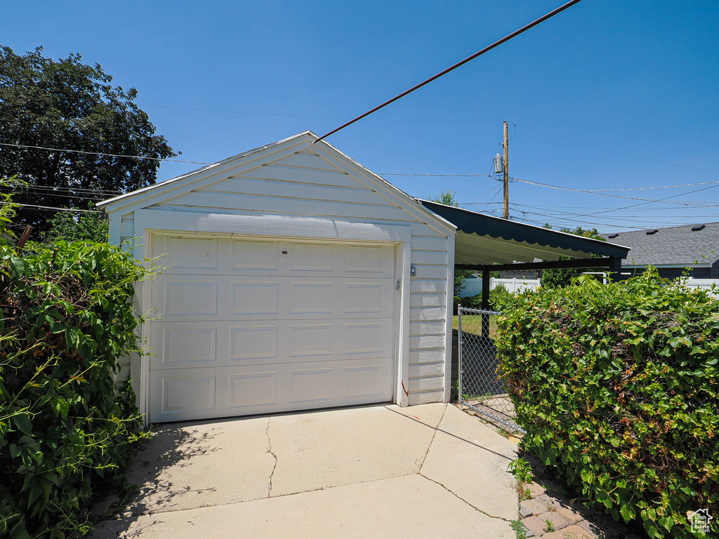 Detached garage featuring concrete driveway