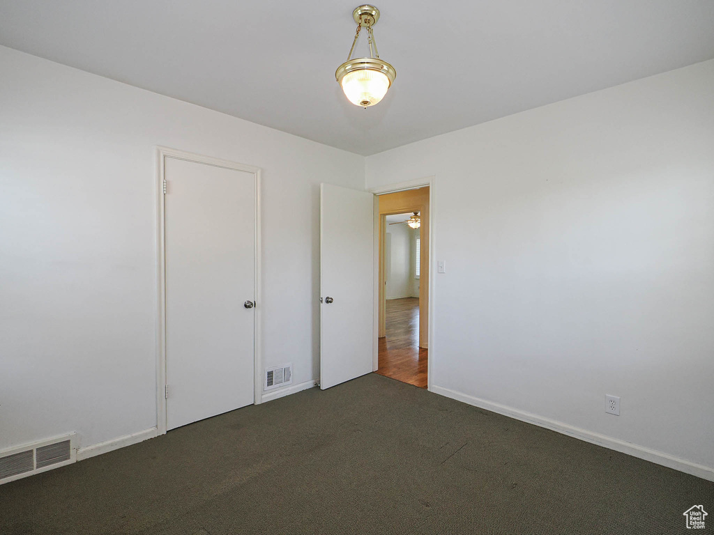 Unfurnished bedroom featuring carpet floors and baseboards