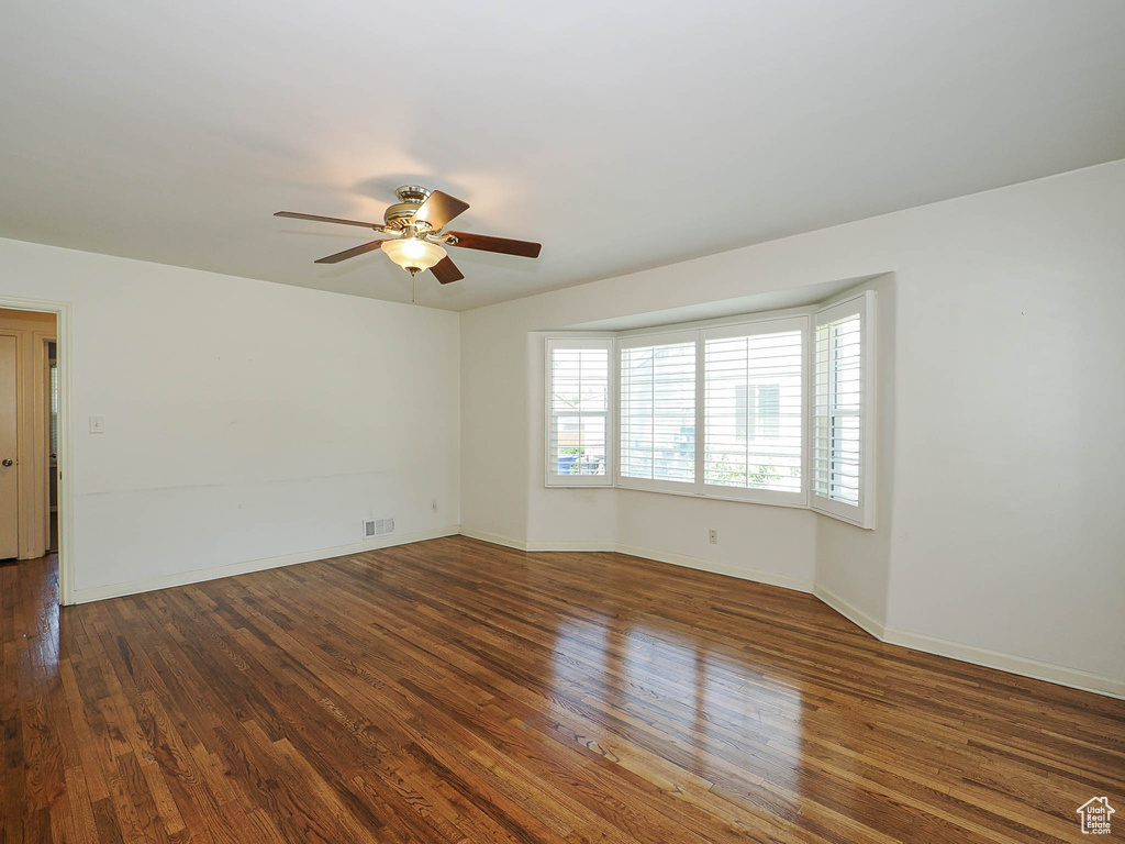 Empty room with ceiling fan and wood finished floors
