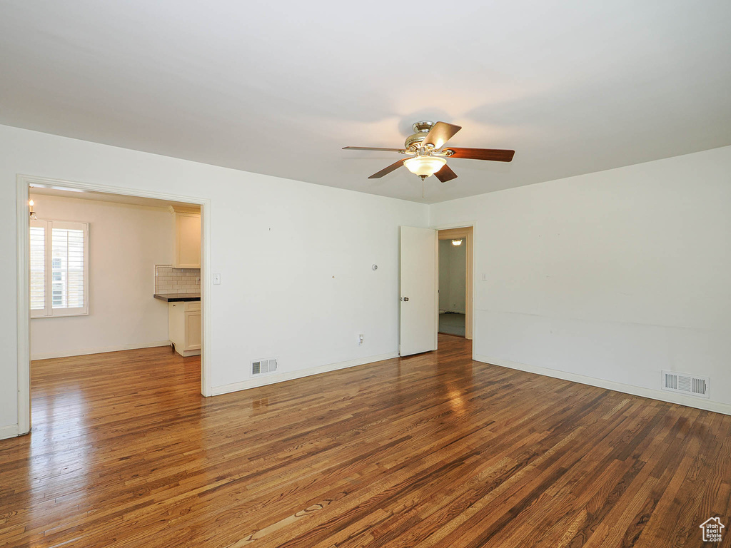 Unfurnished room featuring wood finished floors and ceiling fan
