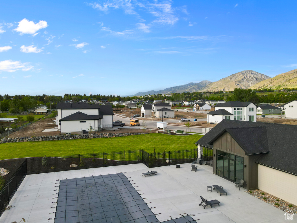 Fenced backyard with a mountain view, a residential view, and a patio