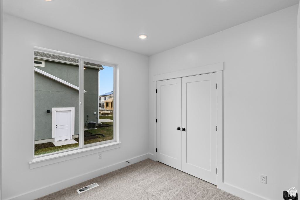 Unfurnished bedroom with carpet and recessed lighting