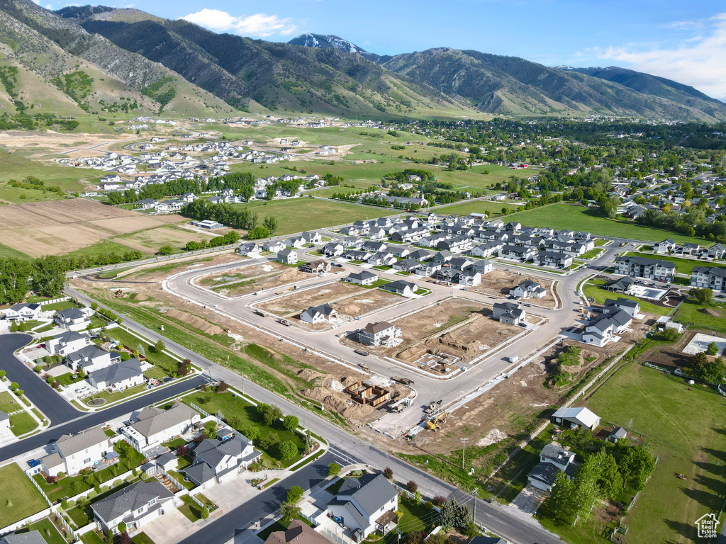 Aerial view of property's location featuring nearby suburban area and mountains