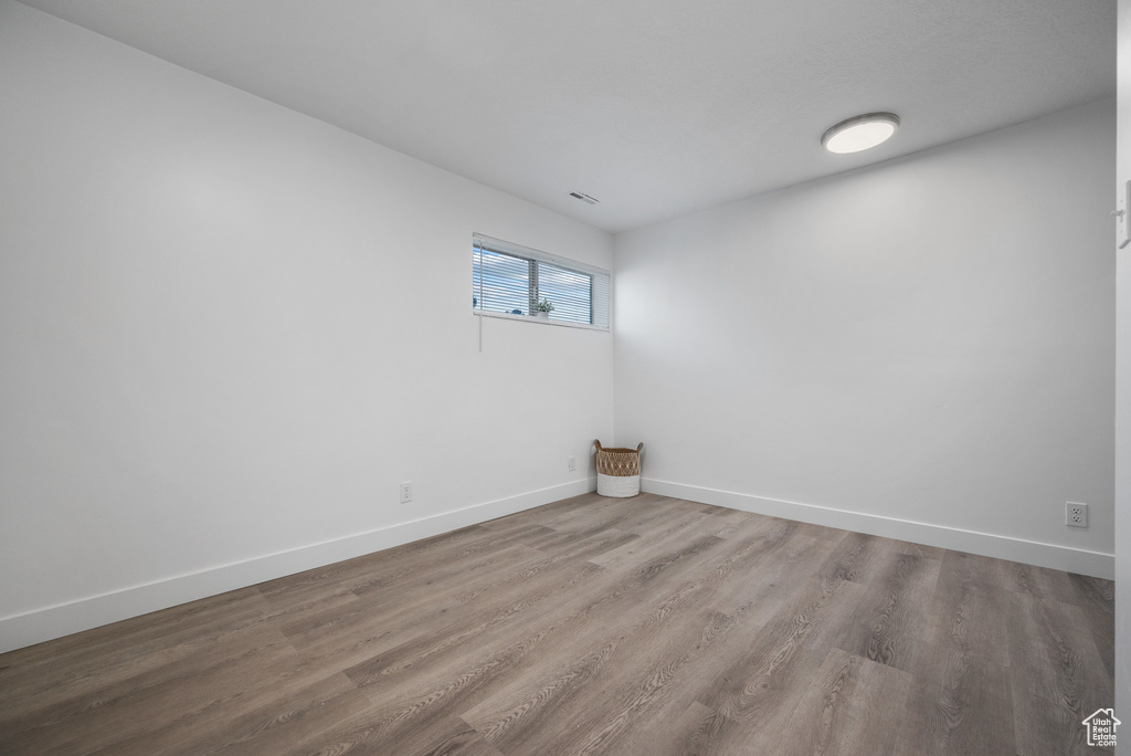 Unfurnished room featuring wood finished floors and baseboards