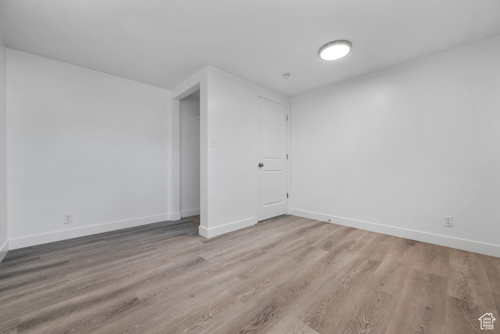 Empty room with wood finished floors and baseboards