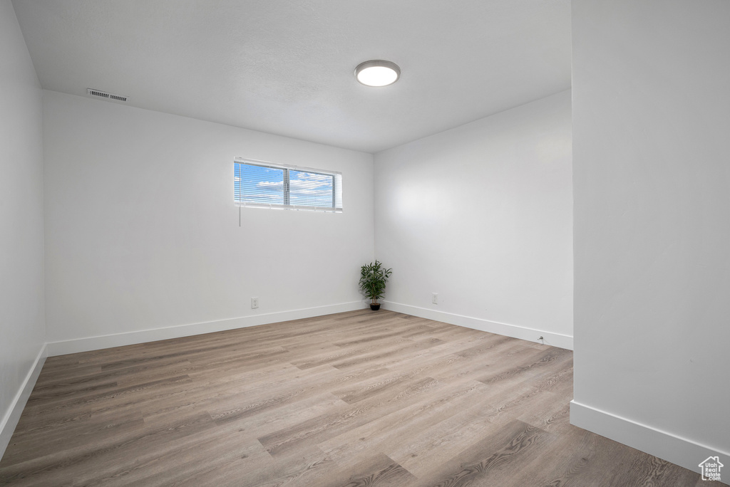 Empty room featuring baseboards and wood finished floors