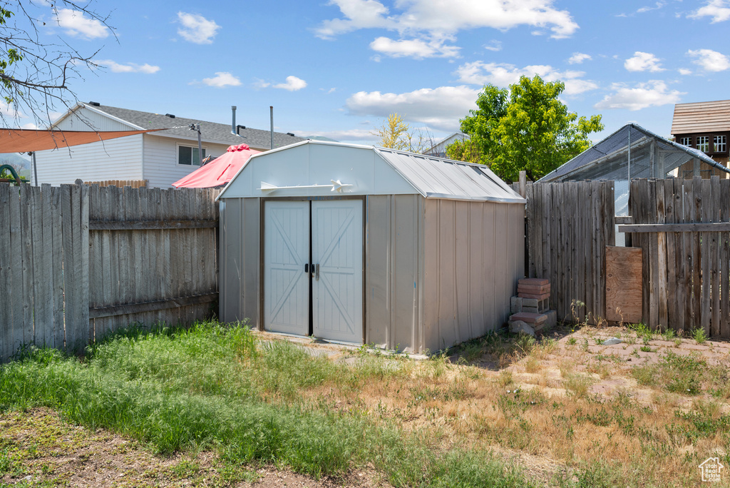 View of shed featuring a fenced backyard