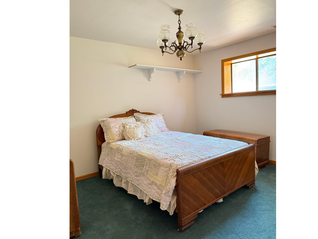Bedroom with carpet and a chandelier