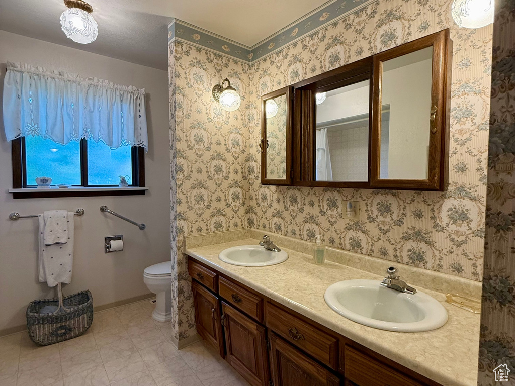Full bathroom featuring double vanity and tile patterned floors