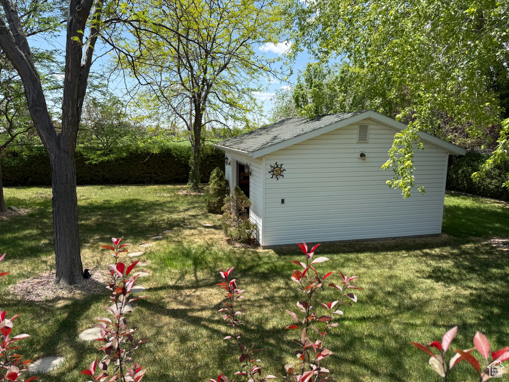 View of grassy yard with an outdoor structure