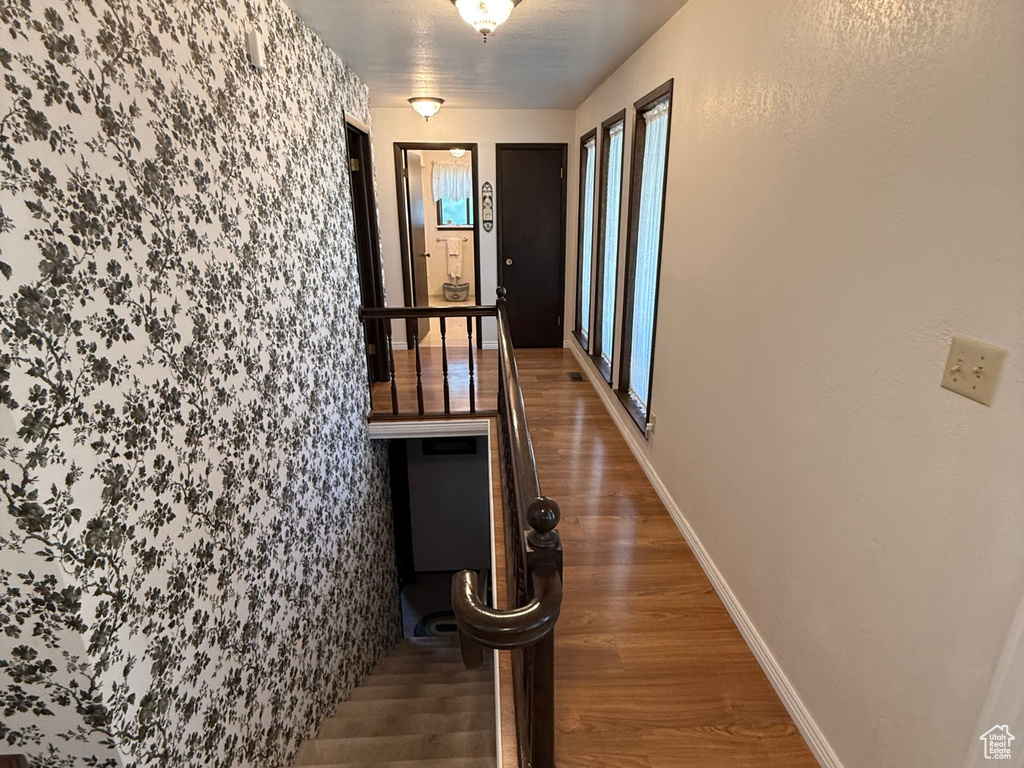 Hall with wood finished floors and baseboards
