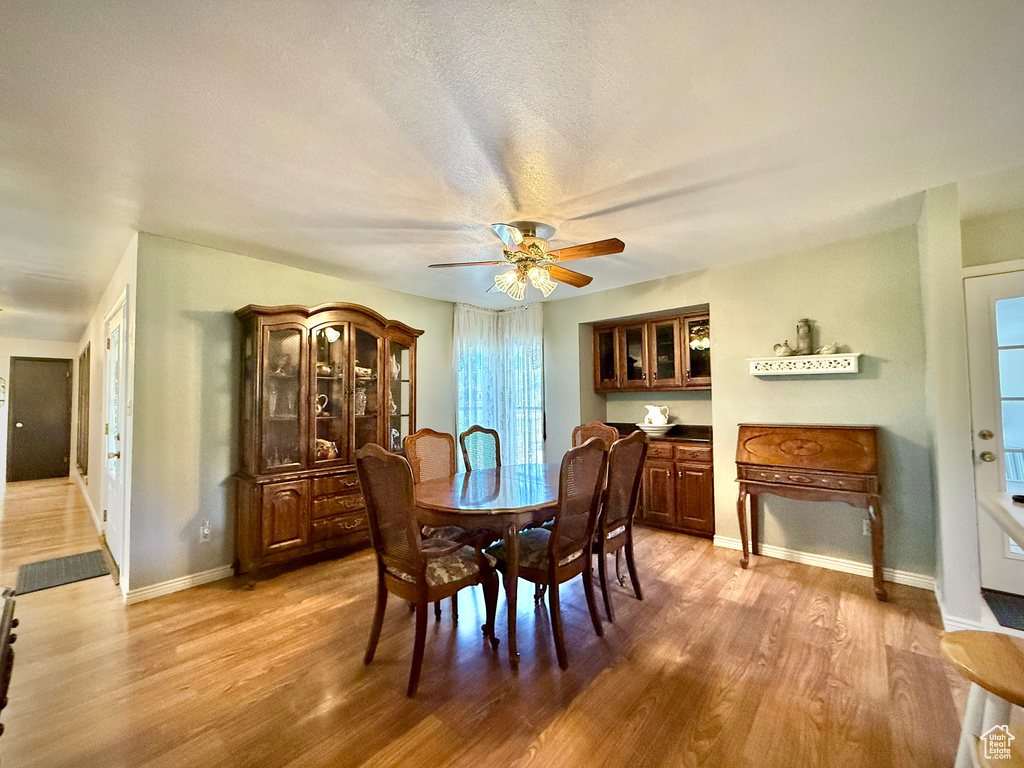 Dining room featuring light wood-style floors and a ceiling fan