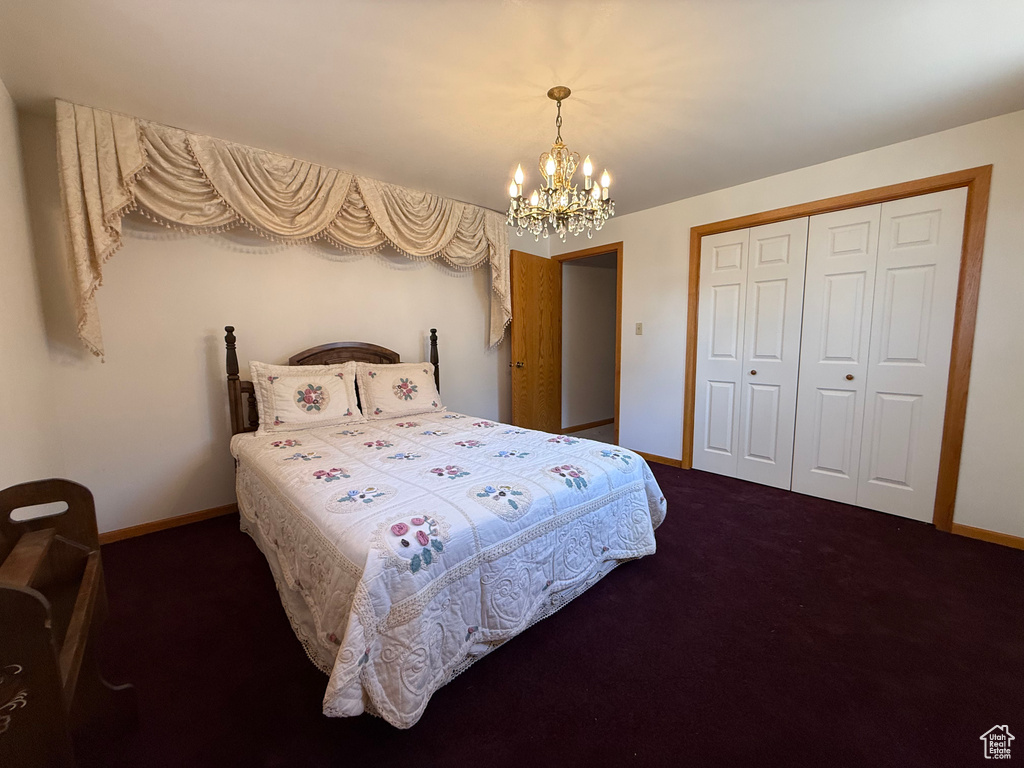 Bedroom with a chandelier, carpet floors, and a closet