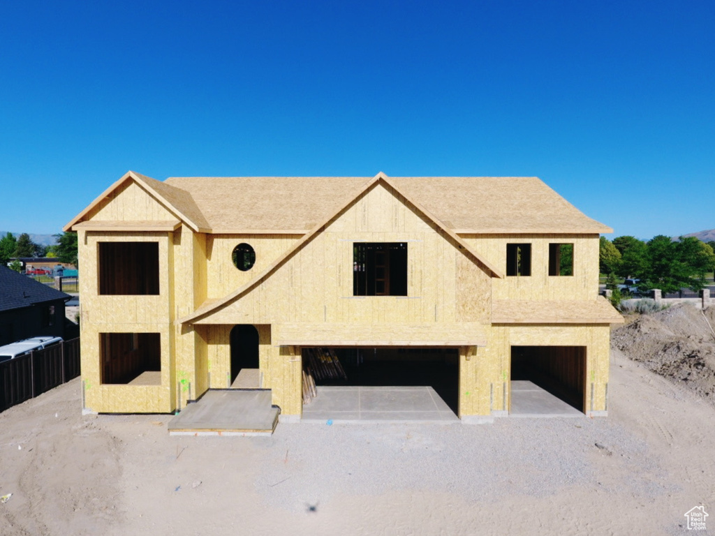Property under construction featuring an attached garage and stucco siding