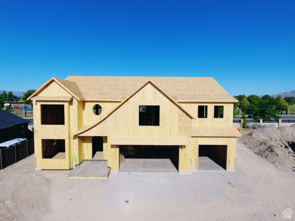 Property in mid-construction featuring a garage and stucco siding