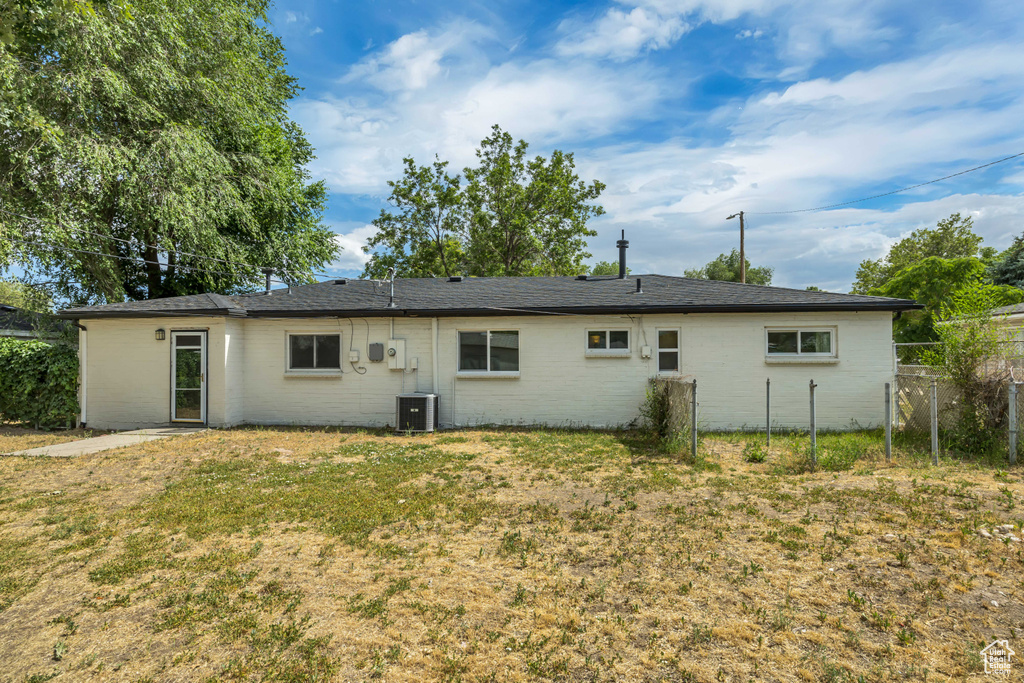 Rear view of property with brick siding
