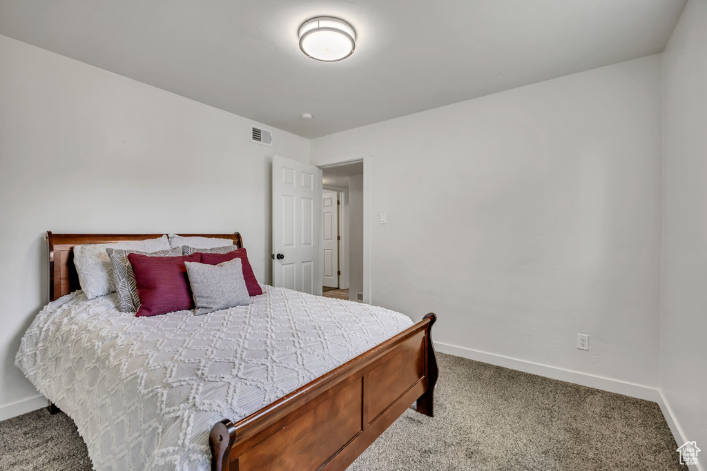 Carpeted bedroom featuring baseboards