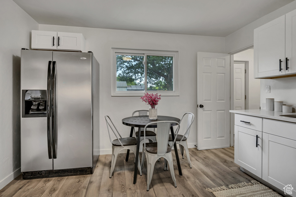 Dining room featuring light wood-style flooring and baseboards