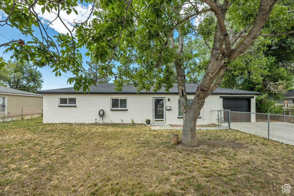 Single story home with concrete driveway, an attached garage, and brick siding