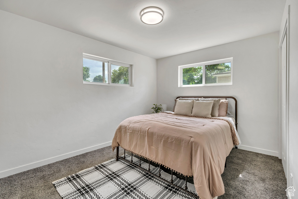 Bedroom with carpet flooring and baseboards