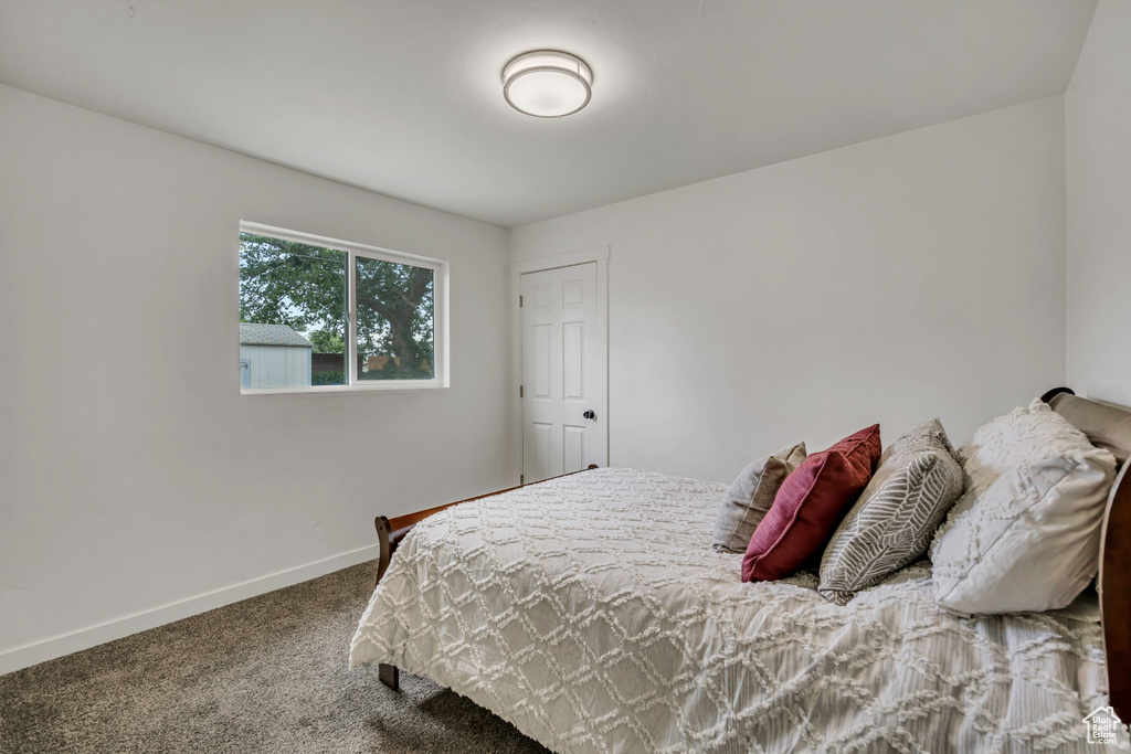 Carpeted bedroom featuring baseboards