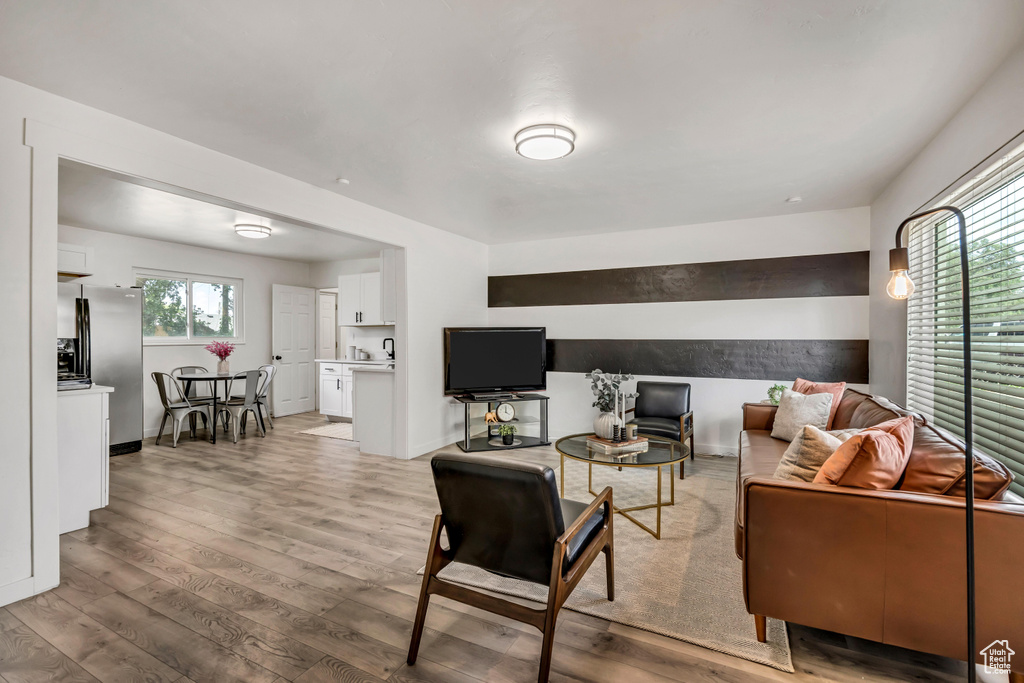 Living room featuring light wood-style flooring and baseboards