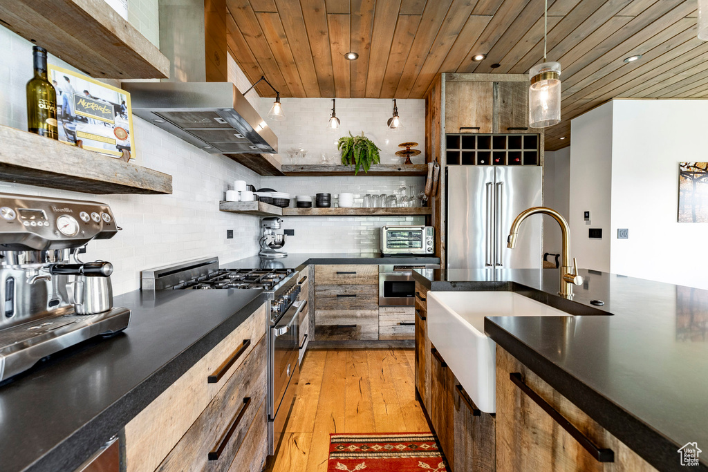 Kitchen featuring stainless steel appliances, open shelves, wooden ceiling, light wood-style floors, and dark countertops