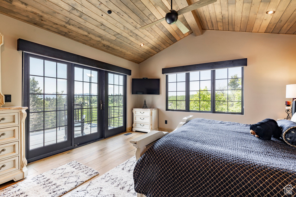 Bedroom with access to exterior, light wood-style floors, wooden ceiling, and recessed lighting