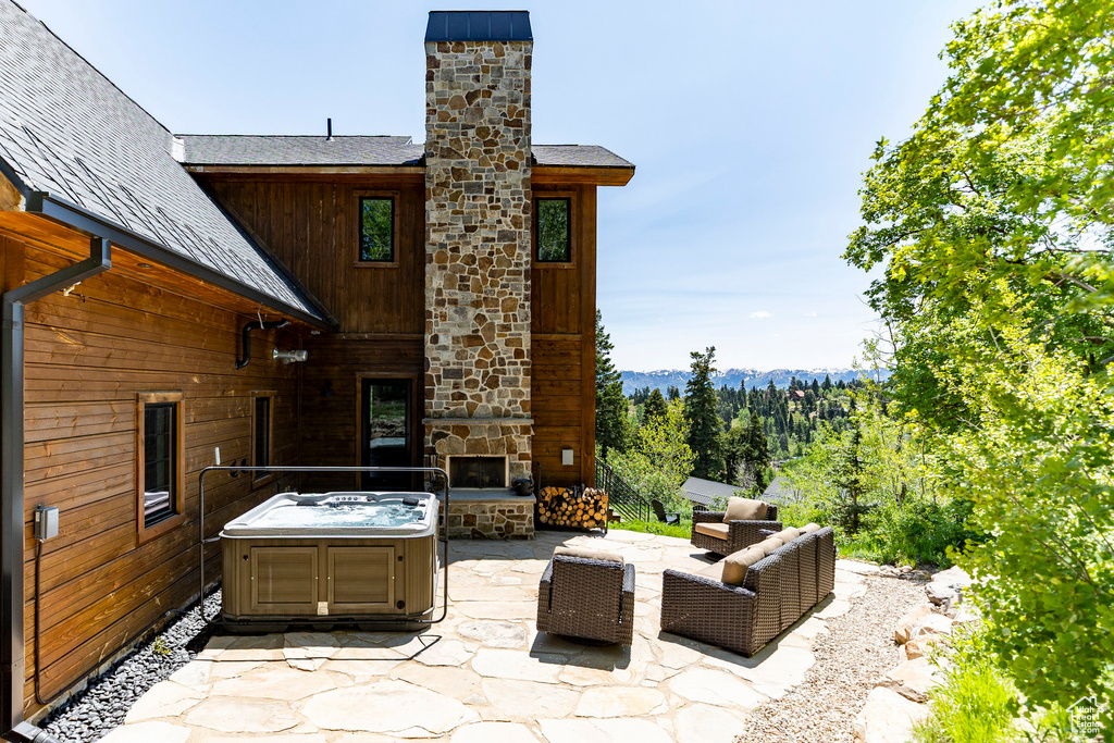 View of patio / terrace with an outdoor living space with a fireplace and a mountain view