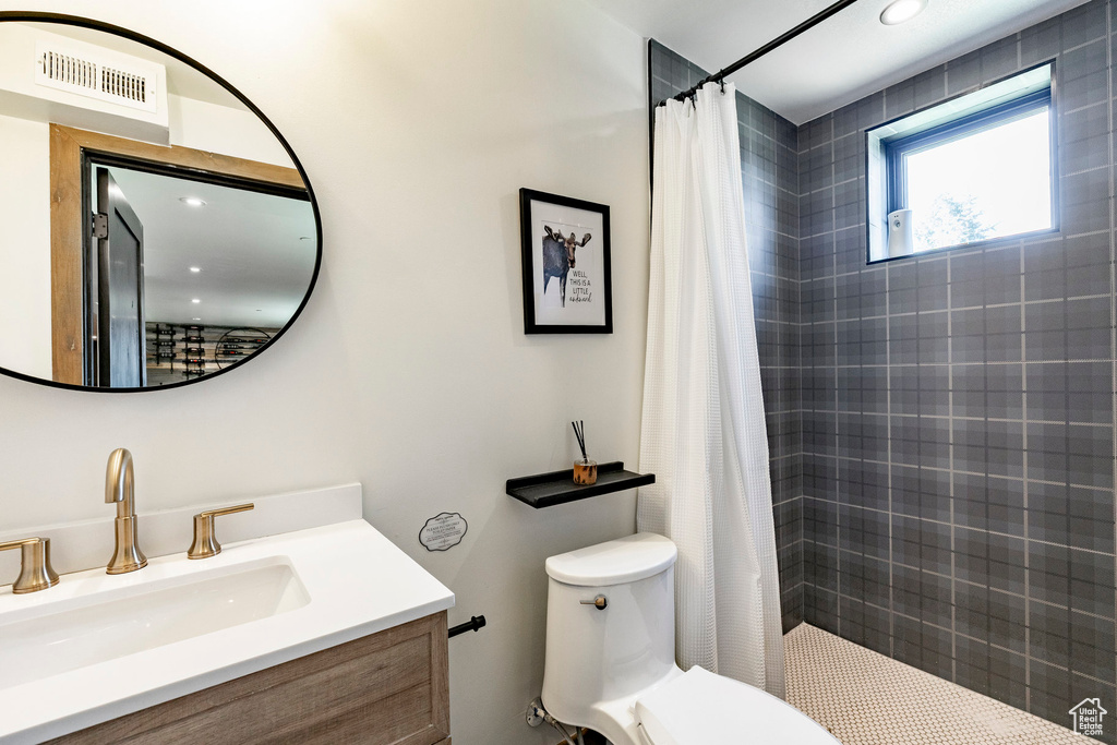 Full bathroom with tiled shower and vanity
