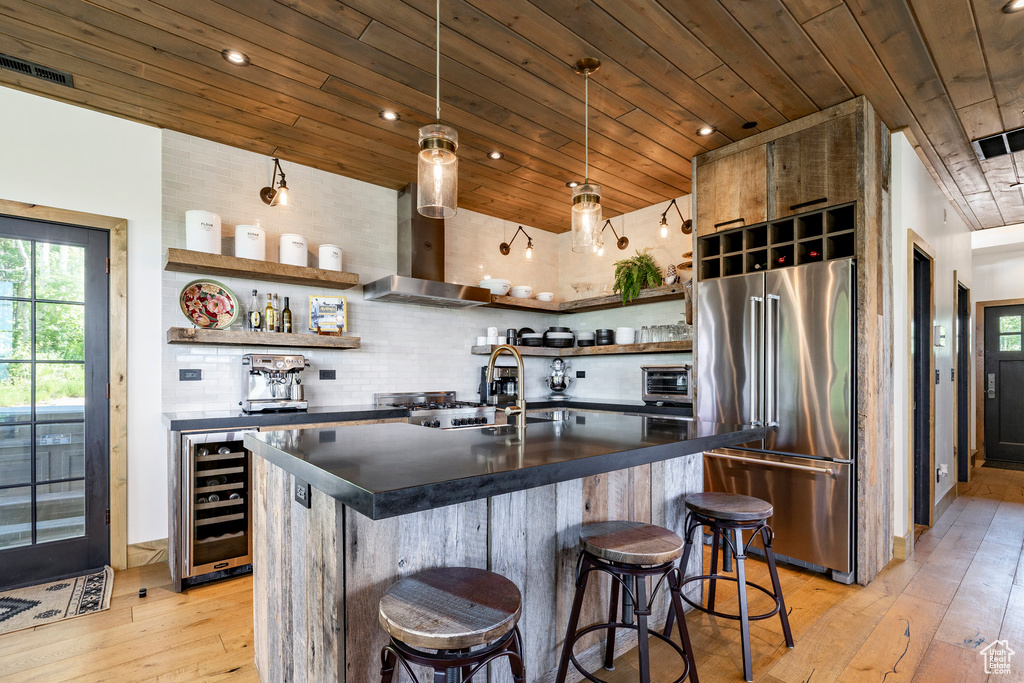Kitchen with high quality fridge, open shelves, dark countertops, wooden ceiling, and light wood-style flooring