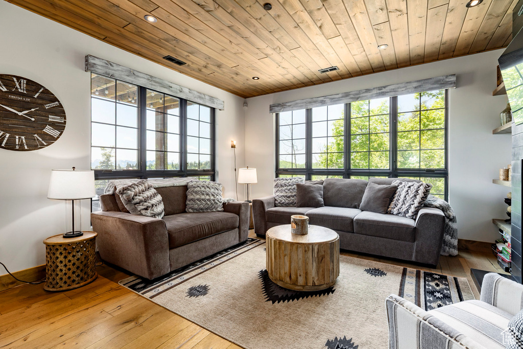 Living area with wood-type flooring, wood ceiling, and recessed lighting