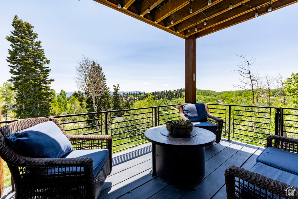 Wooden deck featuring a view of trees