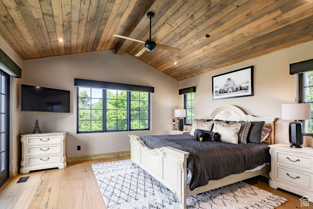 Bedroom with wooden ceiling and light wood-style flooring