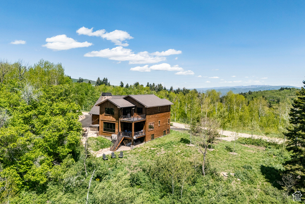 View of subject property with a heavily wooded area