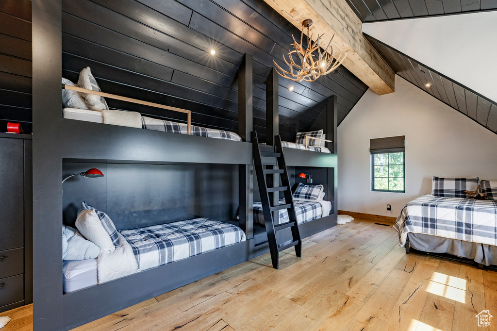 Bedroom with hardwood / wood-style floors and a chandelier